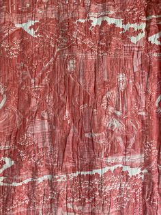 an old red cloth with white designs on it