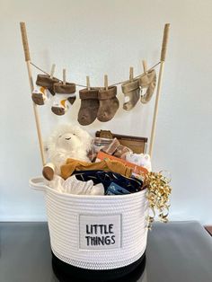 a white teddy bear sitting in a little things basket