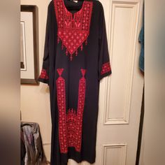 Embroidered Made In Jordan Dress Red Embroidered Long Sleeve Dress, Black Long Sleeve Abaya With Floral Embroidery, Red Long Embroidered Dress, Black Long Dress With Intricate Embroidery, Long Black Dress With Intricate Embroidery, Traditional Black Tunic Dress, Red Embroidered Long Sleeve Abaya, Red Embroidered Long Sleeve Kaftan, Black Long Kaftan With Intricate Embroidery