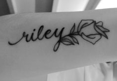 a woman's arm with the word riley written in cursive writing on it