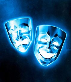 two masks are glowing in the dark with blue lighting behind them and one is wearing a mask