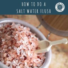 a bowl filled with salt and spoons on top of a table