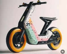 an electric scooter with colorful wheels on the front and back wheel rims