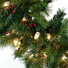 a close up of a christmas tree with lights and ornaments hanging from it's branches