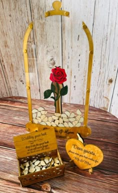 two wooden boxes with flowers in them on top of a table next to each other