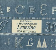 an old book with some type of lettering on the front and back cover, including letters