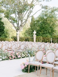 an outdoor ceremony with rows of chairs and flowers