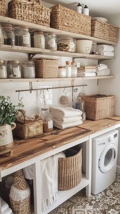 a washer and dryer sitting next to each other in a room with baskets on the wall