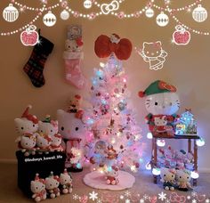 a hello kitty christmas tree is decorated with pink and white lights, ornaments and decorations