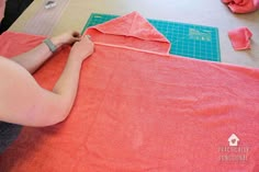 a woman is cutting fabric with scissors