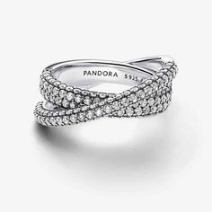 Go three-dimensional with the Pandora Timeless Pavé Crossover Dual Band Ring. Two pavé crossover bands form this striking sterling silver ring. Sparkling stones cover the front and sides of both bands, which have slightly different widths. The wider inner band features the iconic Pandora logo engraved on the inside. The perfect gift for those who love stacking their jewelry, this dual band ring packs double the style in a single piece. Sterling silver & Cubic Zirconia Silver Rings With Modern Twist And Round Cut, Modern Twist Silver Rings With Round Cut, Silver Sterling Silver Bypass Ring With Brilliant Cut, Pandora Logo, Dual Band, Single Piece, Band Ring, Sterling Silver Ring, Three Dimensional