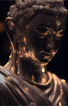 a close up of a buddha statue with lights on it's head and body