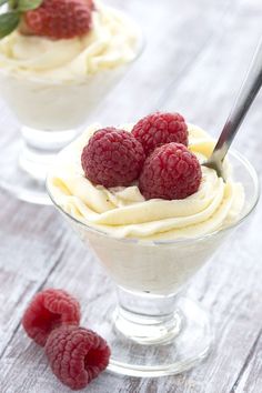 two small desserts with raspberries on top