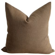 a brown pillow on a white background