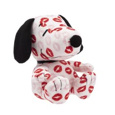 a small stuffed dog with lips on it's face and mouth, sitting upright