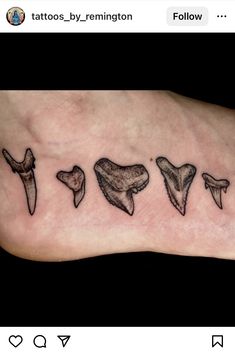 the foot has five different types of tattoos on it, including one that is shaped like an animal's teeth