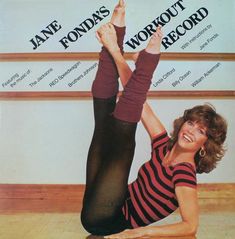 a woman doing yoga on the floor in front of a sign that says jane fondns workout record