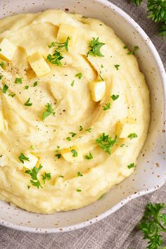 a white bowl filled with mashed potatoes and peas