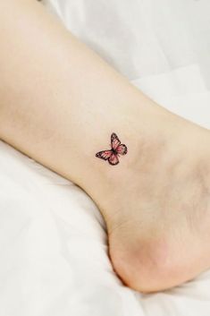 a small butterfly tattoo on the ankle