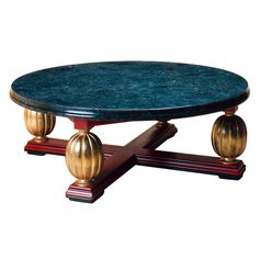 a coffee table with two golden balls on it's legs and a blue marble top