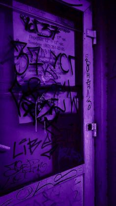 the door is covered in purple graffiti