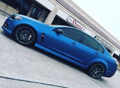 a blue car parked in front of a building