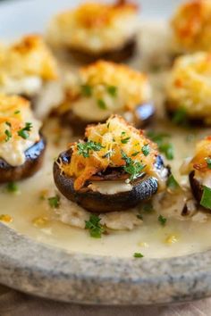 an assortment of mushrooms with cheese and parsley on top