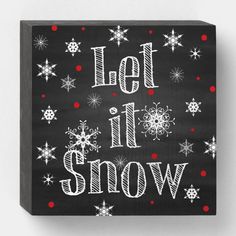 a black and white sign with snowflakes on it that says let it snow