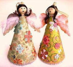 two little angel dolls sitting next to each other