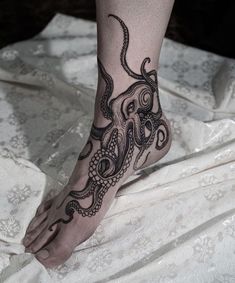 an octopus tattoo is on the foot of a woman's leg and it looks like she has been tattooed