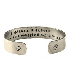 a silver cuff bracelet with the words i found a sister in you married my brother