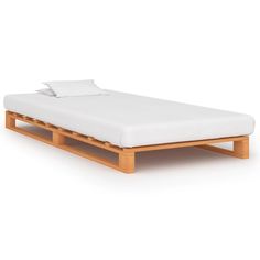 a wooden bed frame with white sheets on it