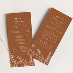 two brown menu cards sitting on top of each other