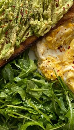 an avocado toast and spinach salad on a plate