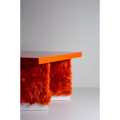 an orange and white table with some fur on it