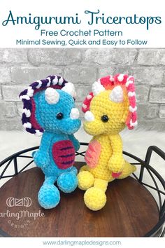 two crocheted stuffed animals sitting on top of a table