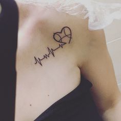 a woman with a heartbeat tattoo on her chest