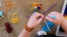 two hands are knitting together with yarn and crochet