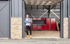 a man standing in the doorway of a garage