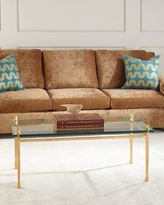 a living room with a couch, coffee table and two books on the end tables