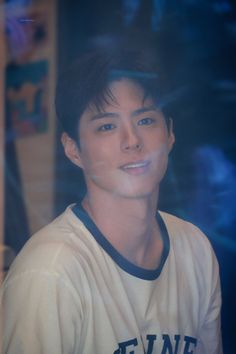 a young man in a baseball uniform looking at the camera