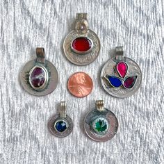 SKU: KJ-023 This listing features a set of 5 beautiful vintage, handmade Afghan silver coin pendants, made from base metal and glass stones in a range of colors. These are authentic Kuchi tribal coin pendants, made by the Kuchi tribes of Pakistan and Afghanistan. This is the EXACT coin set you will be receiving! The coin pendants are vintage and handmade, so imperfections are to be expected. Every effort has been taken to portray the coins as accurately as possible. The US penny is displayed as Nickel-free Round Pendant Jewelry For Vintage Collection, Traditional Nickel-free Round Pendant Jewelry, Traditional One-of-a-kind Round Pendant Jewelry, Traditional Coin Pendant For Jewelry Making, Bohemian Nickel-free Round Disc Jewelry, Bohemian Handmade Round Disc Jewelry, Handmade Bohemian Round Disc Jewelry, Handmade Bohemian Disc Jewelry, Traditional Round Disc Jewelry As Gift