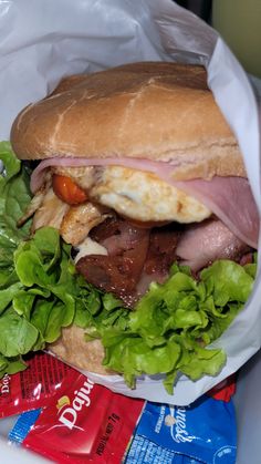 a sandwich with meat, cheese and lettuce