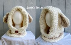 two mannequin heads are covered in white and brown knitted clothing with buttons