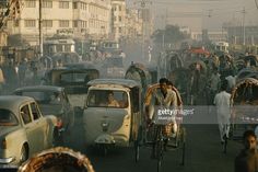 busy city street with cars and people on bicycles