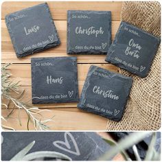 four slate coasters with names on them sitting on a table next to some plants