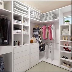 a white closet filled with lots of clothes