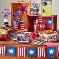 an american patriotic dessert table with red, white and blue stars on the top of it