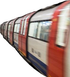 a red and white train traveling down tracks