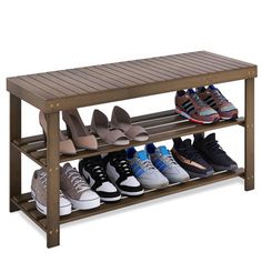 a wooden shoe rack with several pairs of shoes on it